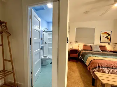 a bedroom with a bed and a bathroom with a toilet at Serene Studio, Yurt Barn near DTLA Silverlake in Glendale