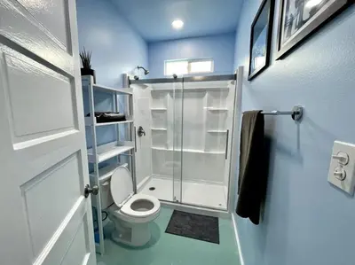 a small bathroom with a toilet and a shower at Serene Studio, Yurt Barn near DTLA Silverlake in Glendale