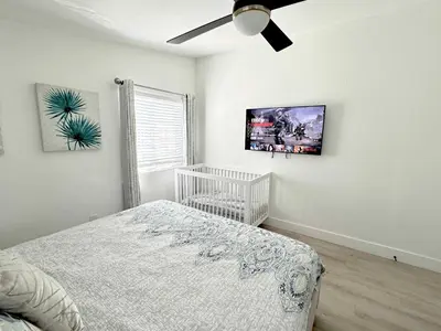 a bedroom with a crib and a ceiling fan at Disneyland Retreat-Pool Spa Game in Anaheim