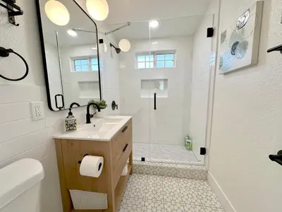 a bathroom with a shower and a sink and a toilet at Disneyland Retreat-Pool Spa Game in Anaheim