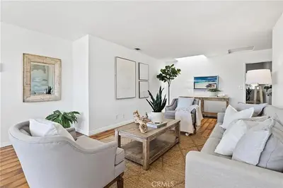 a living room with two white couches and a table at Beachfront 3 Bedroom 3 Bath In Seal Beal, Ca in Seal Beach