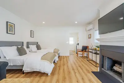 a bedroom with two beds and a fireplace at Elegant Guest unit Universal sleeps 6 hot tub in Los Angeles