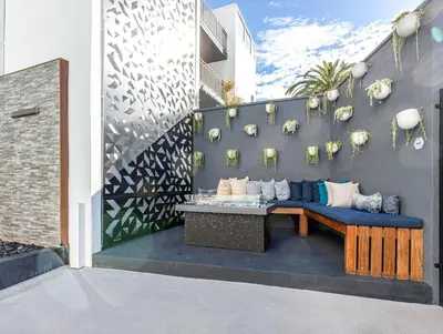a patio with a blue couch against a wall at Redondo Beach 1BR w Pool Gym nr Beach LAX-398 in Redondo Beach