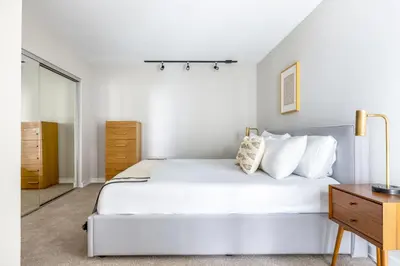 a white bedroom with a large bed and a dresser at Redondo Beach 1BR w Pool Gym nr Beach LAX-398 in Redondo Beach