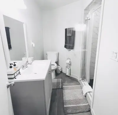 a white bathroom with a sink and a toilet at Lovely Sherman Oaks Studio in Los Angeles