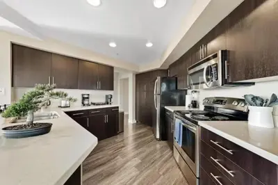 a kitchen with wooden cabinets and a white counter top at Blue Topaz Retreat - Spacious 3BR Gorgeous City views in Los Angeles