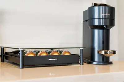 a coffee maker and a tray of buns on a counter at Blue Topaz Retreat - Spacious 3BR Gorgeous City views in Los Angeles