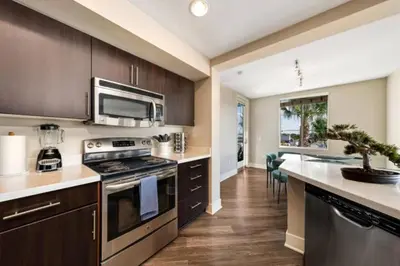 a kitchen with a stove and a microwave at Blue Topaz Retreat - Spacious 3BR Gorgeous City views in Los Angeles