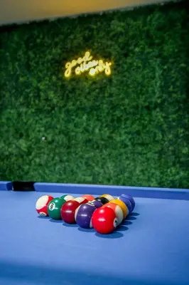 a group of cue balls on a blue billiard table at Charming Disneyland Retreat - Sleeps up to 12 w Game Room, Pool Table, EV w King Bed in Midway City