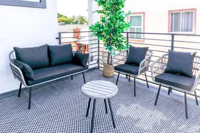 a patio with two chairs and a table and a plant at Cozy Luxe Unit Near Disneyland - Sleeps up to 10! EV Friendly & King Bed in Midway City