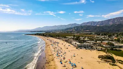 an aerial view of a beach with people and the ocean at Studio 6 Suites Carpinteria, CA Santa Barbara South in Carpinteria