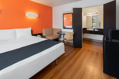 a hotel room with a bed and a desk at Studio 6 Suites Carpinteria, CA Santa Barbara South in Carpinteria