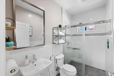 a bathroom with a toilet and a sink and a shower at Stylist Home In Convenient Location! in Temple City