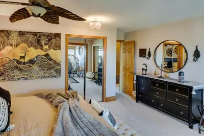 a bedroom with a bed and a dresser and a mirror at Spacious Crestline Retreat 1 Mi to Lake Gregory in Crestline