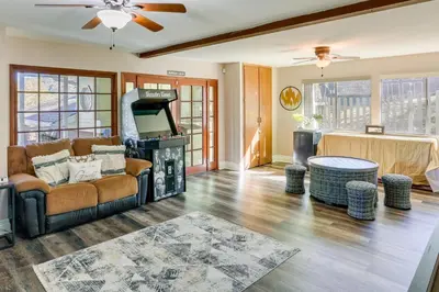 a living room with a couch and a tv at Spacious Crestline Retreat 1 Mi to Lake Gregory in Crestline