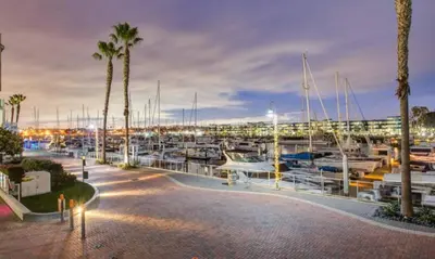 a marina at night with boats and palm trees at The Coral Loft - Marina Bliss Water view 2BR Pool, Gym in Los Angeles