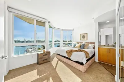 a bedroom with a large bed and a large window at The Coral Loft - Marina Bliss Water view 2BR Pool, Gym in Los Angeles