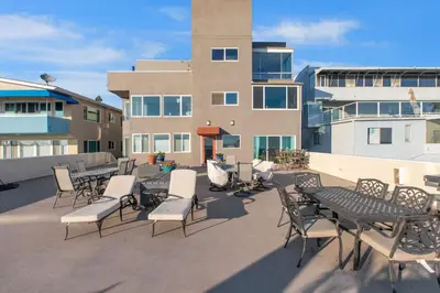 a group of tables and chairs on a patio at On the Boardwalk in Long Beach