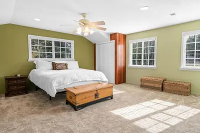 a bedroom with a bed and a ceiling fan at Serene Lakefront Haven by Rather Be Properties in Big Bear Lake