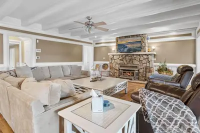 a living room with a couch and a fireplace at Serene Lakefront Haven by Rather Be Properties in Big Bear Lake