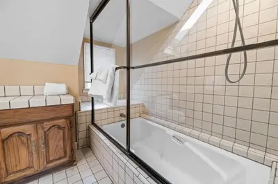 a bathroom with a tub and a toilet and a sink at Serene Lakefront Haven by Rather Be Properties in Big Bear Lake