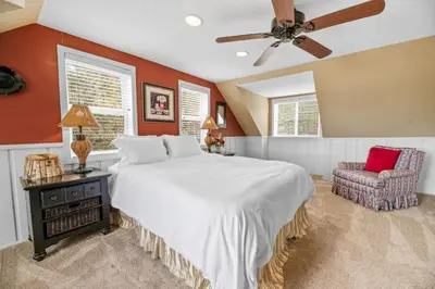 a bedroom with a large bed and a ceiling fan at Serene Lakefront Haven by Rather Be Properties in Big Bear Lake