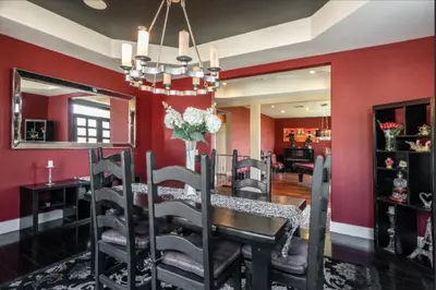 a dining room with red walls and a table with chairs at Hills of Studio City, your serene home away from Home in Studio City