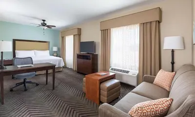 a hotel room with a bed and a desk at Homewood Suites by Hilton San Bernardino in San Bernardino