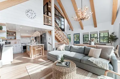 a living room with a couch and a kitchen at Majestic Lakeview Lodge in Lake Arrowhead