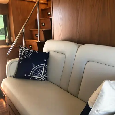 a white couch with a black pillow on it at Luxury Afloat Yacht Paradise 3 bedrooms 3bath 5 beds with full Marina view in Los Angeles