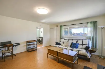 a living room with a couch and a table at Lakewood Home about 5 Mi to Knotts Berry Farm! in Lakewood