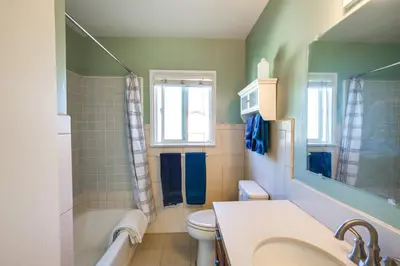 a bathroom with a sink and a toilet and a tub at Lakewood Home about 5 Mi to Knotts Berry Farm! in Lakewood