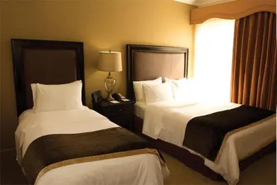 a hotel room with two beds and a window at The Inn at UCLA in Los Angeles