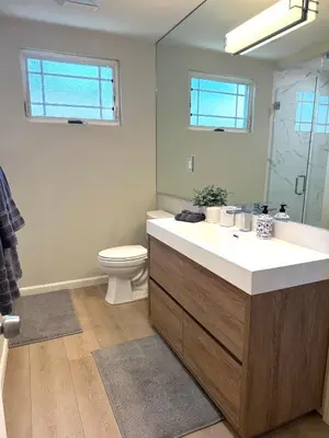 a bathroom with a sink and a toilet and a mirror at Coastal Escape in Redondo Beach in Redondo Beach