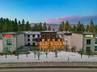 a hotel in the middle of a snow covered yard at Hampton Inn Big Bear Lake in Big Bear Lake
