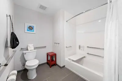 a white bathroom with a toilet and a bath tub at Hampton Inn Big Bear Lake in Big Bear Lake