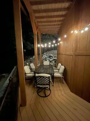 a porch with a table and chairs on a deck at Peaceful Cabin Home with Breathtaking View! in Big Bear City