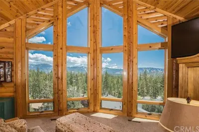 a room with a large window with a view of the mountains at Peaceful Cabin Home with Breathtaking View! in Big Bear City