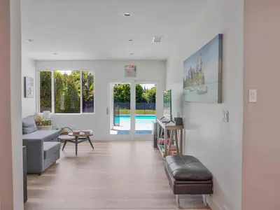 a living room with a couch and a pool at Hollywood Dream pool home & king beds in Los Angeles