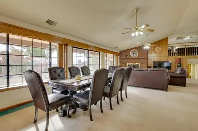 a dining room with a table and chairs and a couch at Spacious California Oasis Patio, Fireplace and Pool in Apple Valley