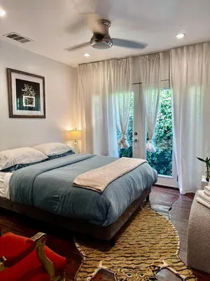 a bedroom with a bed and a large window at Spacious Resort Getaway @ Echo Park Ranch - Luxury indoor/ outdoor home steps from Sunset Blvd, Echo Park Lake, Dodgers Stadium in Los Angeles