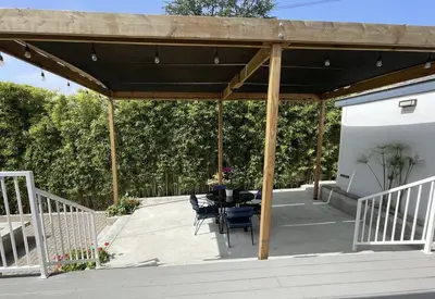 a pavilion with a table and chairs on a patio at Spacious Resort Getaway @ Echo Park Ranch - Luxury indoor/ outdoor home steps from Sunset Blvd, Echo Park Lake, Dodgers Stadium in Los Angeles