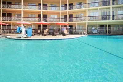 a large swimming pool in front of a hotel at Ramada by Wyndham Burbank Airport in Burbank