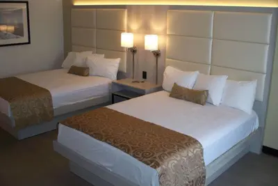 a hotel room with two beds and two lamps at Ramada by Wyndham Burbank Airport in Burbank