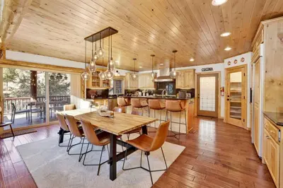 a kitchen with a wooden ceiling and a table and chairs at Gold Rush Lodge Big Bear~Hot Tub~ Games~ in Big Bear Lake