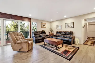 a living room with leather chairs and a table at A Hidden Asset Big Bear~ Hot Tub~ Walk to Village~ in Big Bear Lake