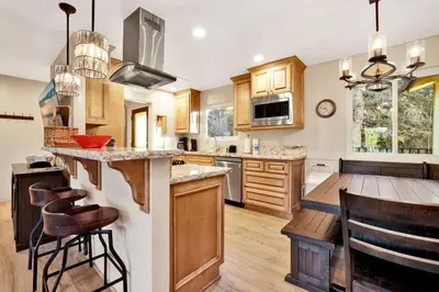 a kitchen with wooden cabinets and a counter top at A Hidden Asset Big Bear~ Hot Tub~ Walk to Village~ in Big Bear Lake