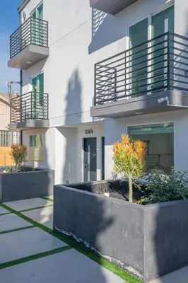a building with two balconies on top of it at Normandie Hostel in Los Angeles