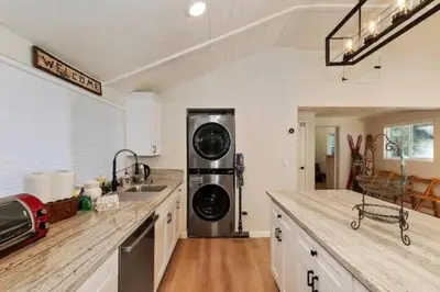 a kitchen with a sink and a washer and dryer at Modern Moab: Near Boulder Bay + Spa + Large Yard in Big Bear Lake