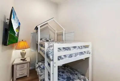 a white bunk bed in a room with a lamp at Modern Moab: Near Boulder Bay + Spa + Large Yard in Big Bear Lake